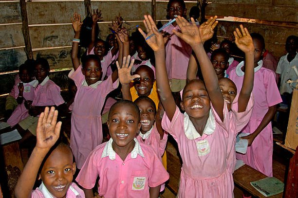 Children in classroom with new desks funded by tourism